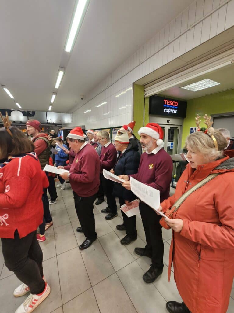 Carol singing mix-up turns into a Joyful night of community spirit at Epsom station 